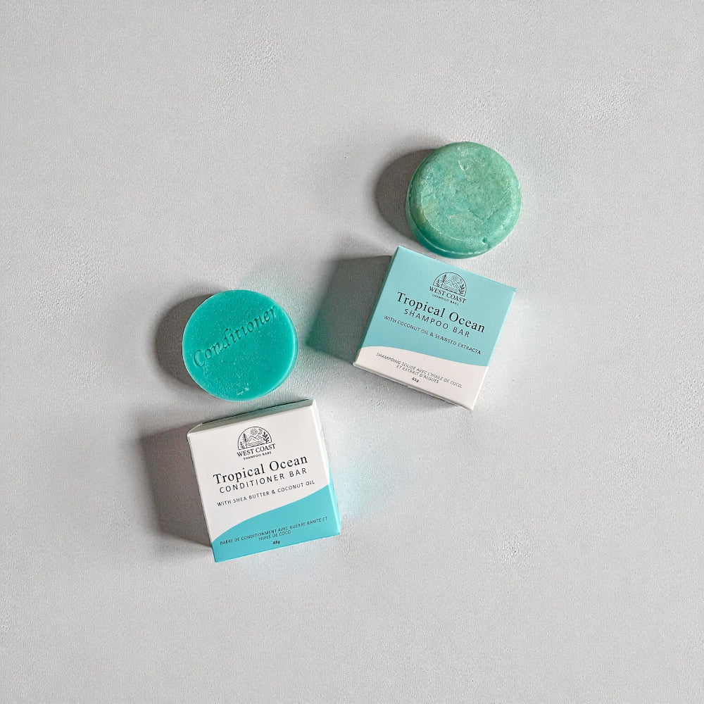 Two Tropical Ocean shampoo bars with their packaging on a light gray background