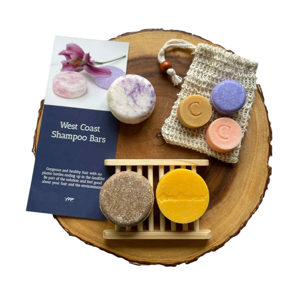 Collection of West Coast Shampoo Bars on a wooden surface with a leaflet.